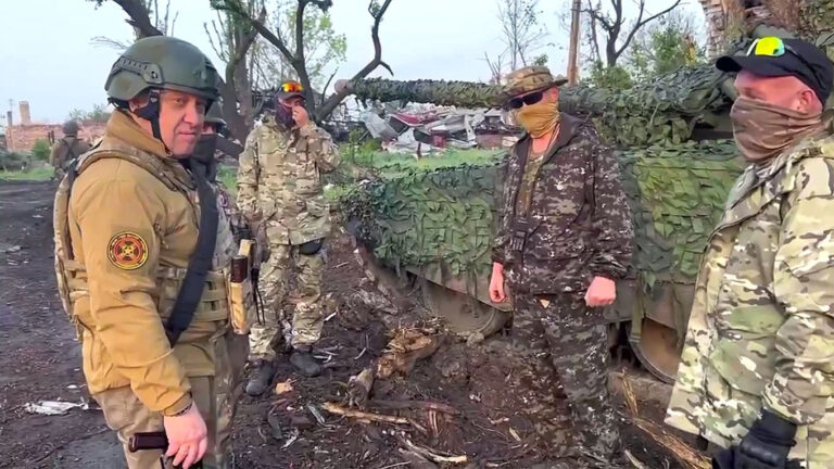 Wagner leader Yevgeny Prigozhin (L) pictured with fighters in the eastern Ukrainian city of Bakhmut last month. Prigozhin Press Service